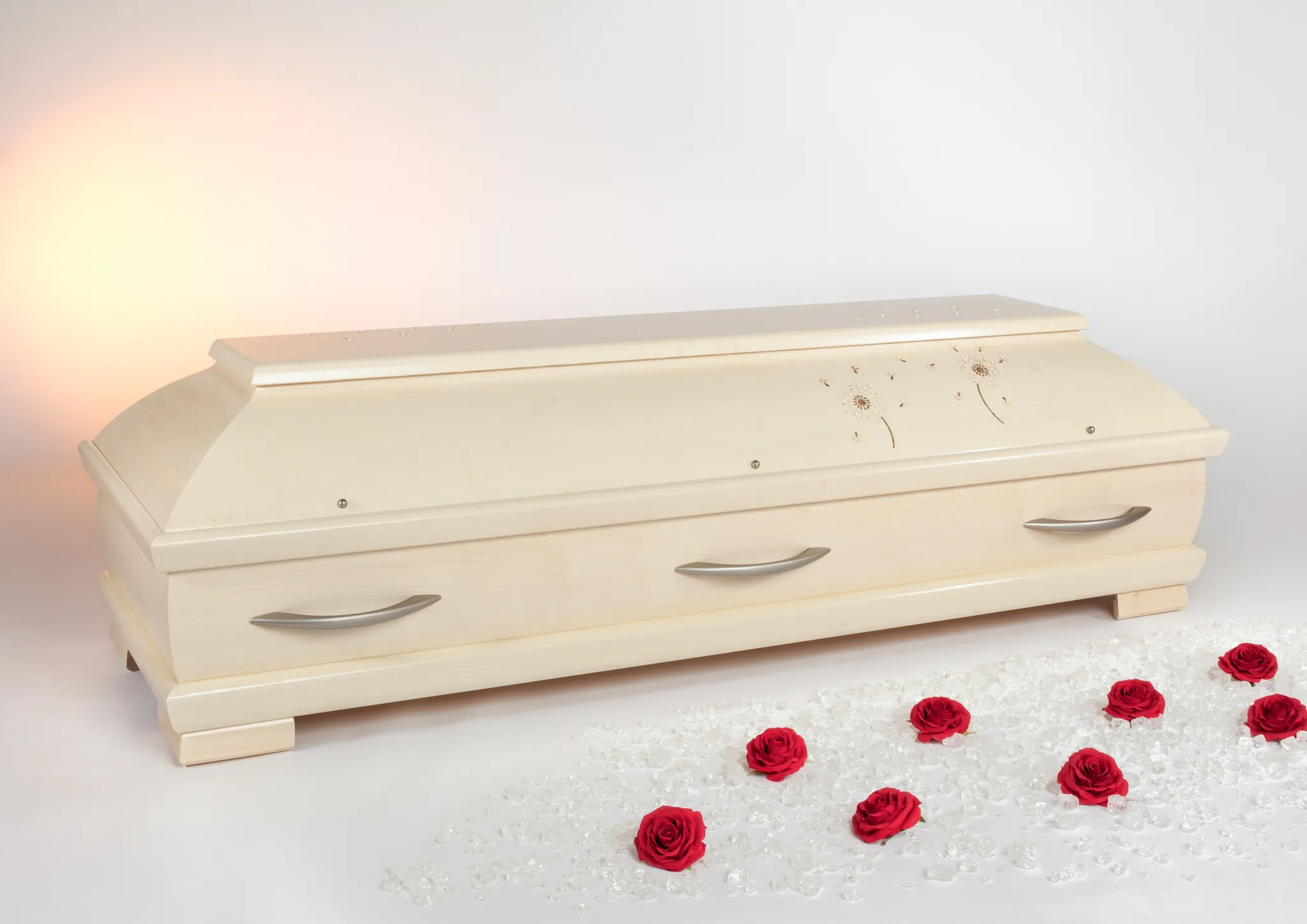 Erdbestattung – gepflegtes Grab mit Blumenschmuck und Pusteblume